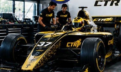 CTR engineers working on a gold-and-black F4 car #37 in the garage.