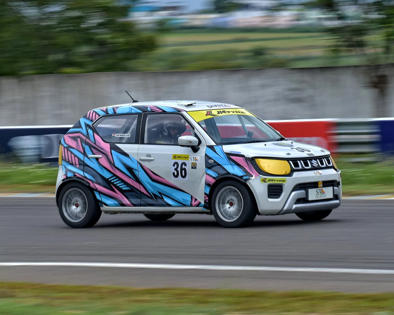 Ignis cars at speed on the back straight