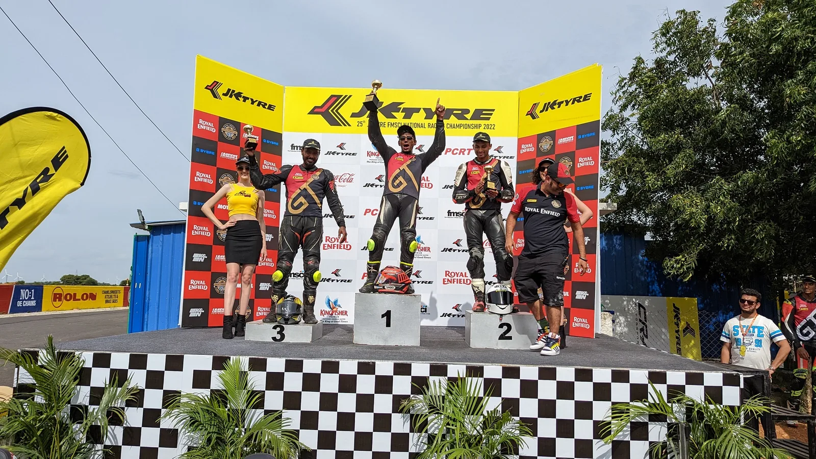 Drivers celebrate on the podium at Kari Motor Speedway