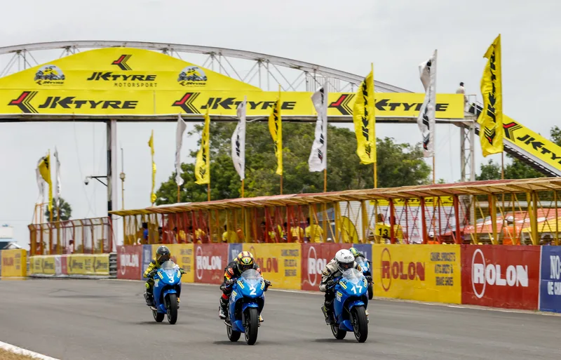 Motorcycles race past the JK Tyre bridge at Kari Motor Speedway, Coimbatore